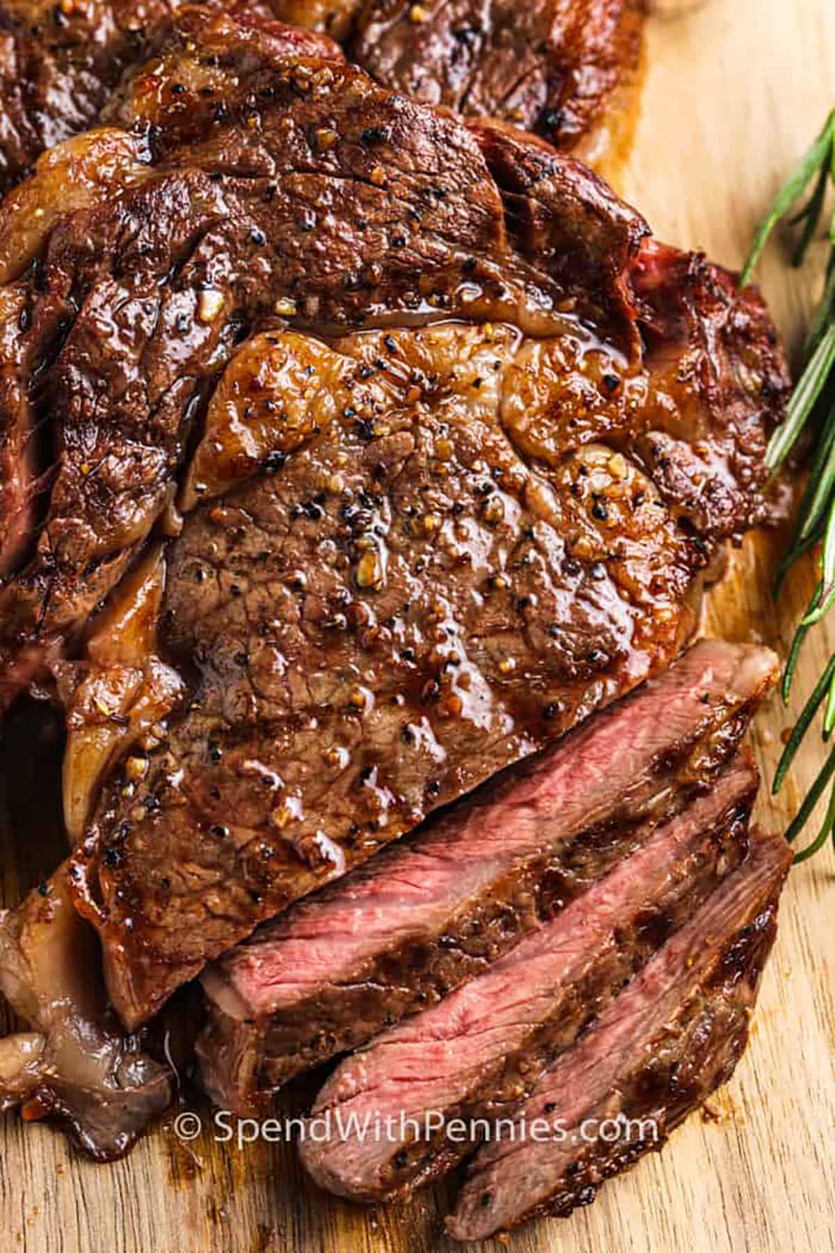 Pan-Seared Peppercorn Ribeye Steaks with Roasted Garlic Butter