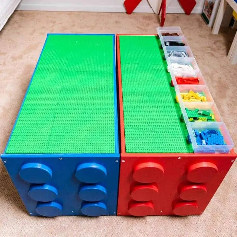 IKEA TROFAST LEGO building station with red and blue frames, white storage drawers and sorting bins on top